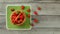 Tabletop view, basket with strawberries, some of them spilled on