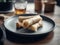 Tabletop view of delicious spring rolls with basil leaves on an elegant restaurant plate.