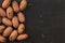 Tabletop view, whole pecan Carya illinoinensis nuts with spots on shells Turkish variety on black marble desk, space for text