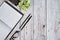 Tabletop workspace with notebook, glasses, pen. White wood, top view overhead