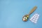 Tablets and capsules with vitamins in wooden spoon on blue background. Copy space, selective focus. The concept of medication,