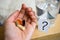 Tablets ,pills in hand near a glass of water and question mark