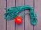 tackle to facilitate the supply of the mooring cable to the shore. A coil of thin green rope with a plastic red ball on the end.