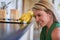 Tackling kitchen tasks. a young woman cleaning a kitchen surface.