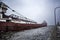 Taconite-loaded freighter/container ship passing by lighthouse