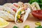 Tacos - wheat tortilla with meat, vegetables, greens and corn with tomato sauce