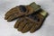 Tactical gloves on light gray background. Military training equipment