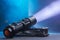 Tactical waterproof flashlight. LED flashlight shines on the table in smoke