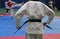 Taekwondo fighter adjusting his belt before competition match detail