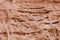 Tafoni weathering in red natural sandstone wall