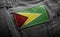 Tag on dark clothing in the form of the flag of the Guyana