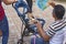 Tagaytay, Cavite, Philippines - A man fans his grandchild to alleviate the heat during a family getaway