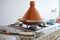 Tagine dish. Vegetables in tagine pot steaming on stove at home kitchen. Moroccan cuisine, culinary and culture