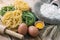 Tagliatelle and ingredients with background