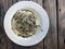 Tagliatelle Italian pasta with forest mushroom, vegetables and pesto sauce