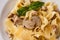 Tagliatelle vegetarian Pasta Dish with Mushrooms decorated with basil. Delicious lunch with pasta and white mushrooms