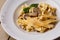 Tagliatelle vegetarian Pasta Dish with Mushrooms decorated with basil. Delicious lunch with pasta and white mushrooms