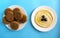 Tahini sauce with pita bread on blue background. Flat lay, top view. Hummus with olives and  flatbread.