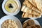 Tahini sauce, pita bread, rice and falafel on dark wooden background. Flat lay, top view.