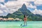 Tahiti Bora Bora island vacation recreational activity watersport woman paddleboarding on SUP Stand Up Paddle Board at