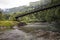 Tahiti. The bridge through the river in mountains.