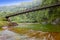 Tahiti. The bridge through the river in mountains.