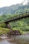 Tahiti. The bridge through the river in mountains.