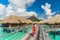 Tahiti luxury hotel honeymoon travel vacation tourist woman walking at luxury resort in overwater bungalows villas. View