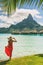 Tahiti resort travel honeymoon destination tourist woman walking on beach of private island at overwater bungalows