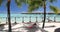 Tahiti Travel luxury vacation - woman relaxing sleeping on hammock at resort