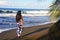 Tahitian girl with her long hair walking on the beach in Tahiti