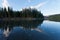 Taiga mirrored on Steward River near town of Mayo