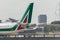 Tail of an Alitalia regional airplane taxiing at London City Airport after landing