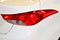 Tail light of a white saloon car