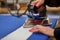 The tailor ironing the white fabric.