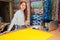 Tailor small business idea.redhaired ginger woman in cotton shirt stand in her dressmaking atelier studio