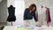 Tailor woman measures cloth use tape on table to make pattern to future clothes.