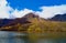 Taisho Pond at Kamikochi, Japan. The still blue waters of the pond reflect the surrounding forested mountains.