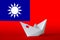 Taiwan flag depicted on paper origami ship closeup. Handmade arts concept