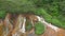 TAIWAN, JIUFEN - MAY, 2023: Aerial Footage of the Golden Waterfall, famous landmark in Jiufen, Taiwan