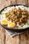 Taiwanese braised minced pork minced with rice and boiled eggs close-up in a bowle. vertical