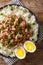 Taiwanese braised minced pork minced with rice and boiled eggs close-up in a bowle. Vertical top view