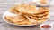 Taiwanese food - delicious flaky scallion pie pancakes on bright wooden table background