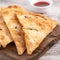 Taiwanese food - delicious flaky scallion pie pancakes on bright wooden table background