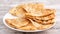 Taiwanese food - delicious flaky scallion pie pancakes on bright wooden table background