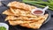 Taiwanese food - delicious flaky scallion pie pancakes on bright wooden table background