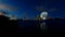 Taj Mahal against full moon with beautiful lake reflections, view from Yamuna River