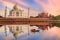 Taj Mahal Agra at twilight as seen from Mehtab Bagh with view of boat on river Yamuna