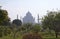 Taj Mahal in Agra, Uttar Pradesh, India. Look in a morning haze through a garden on opposite river bank