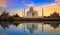 Taj Mahal historic white marble mausoleum on the banks of river Yamuna at sunset at Agra India